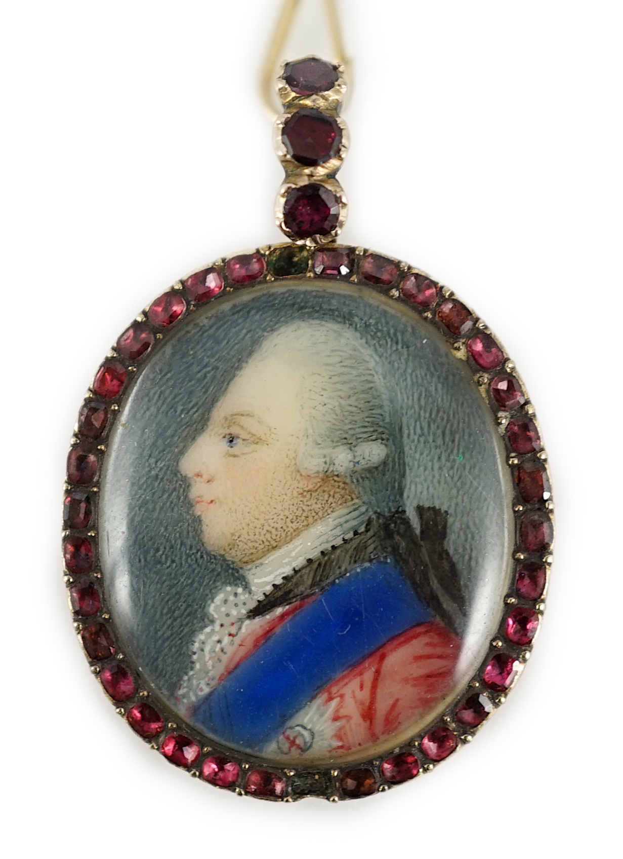 A George III Royal Presentation gold mounted and garnet set oval pendant, with inset miniature portrait of a gentleman to dexter, verso engraved 'The Gift of Queen Charlotte to E. Whitfield, 1770